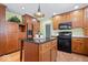 Kitchen with wood cabinets, center island, and black appliances at 10333 E 211Th St, Noblesville, IN 46062