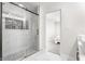 Sleek bathroom featuring a glass-enclosed shower with marble tile and a view into the bedroom at 1533 Harlan St, Indianapolis, IN 46203