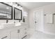 Elegant bathroom with double vanity sinks, black fixtures, and marble-look tile flooring at 1533 Harlan St, Indianapolis, IN 46203