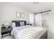 Bright bedroom featuring neutral walls, a modern bed, and a sliding barn door to bathroom at 1533 Harlan St, Indianapolis, IN 46203