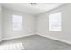 Bright, airy bedroom with two large windows for natural light and neutral carpeting at 1533 Harlan St, Indianapolis, IN 46203