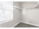 Spacious walk-in closet with carpeted floor, shelving, and a window for natural light at 1533 Harlan St, Indianapolis, IN 46203
