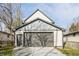Exterior view of a three-car garage with a gray door and light siding details at 1533 Harlan St, Indianapolis, IN 46203