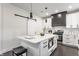 Modern kitchen with white cabinetry, island seating, and stainless steel appliances at 1533 Harlan St, Indianapolis, IN 46203