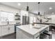 Bright kitchen with white cabinets, island seating, and modern appliances at 1533 Harlan St, Indianapolis, IN 46203