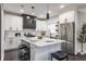 Bright kitchen with white cabinets, stainless steel appliances, and central island with seating at 1533 Harlan St, Indianapolis, IN 46203