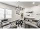 Modern living room featuring leather sofas, stylish rug, and elegant chandelier at 1533 Harlan St, Indianapolis, IN 46203