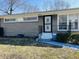 Charming home featuring gray brick, updated windows, and a secure front entrance at 1607 Elmhurst Dr, Indianapolis, IN 46219