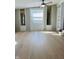 Bright living room with neutral walls, hardwood floors, ceiling fan, and plenty of natural light at 1607 Elmhurst Dr, Indianapolis, IN 46219