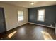 This bedroom features two windows, hardwood floors, and neutral walls at 1632 W 17Th St, Anderson, IN 46016