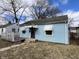 Quaint light blue single-story home with white awning accents and a small front porch at 1632 W 17Th St, Anderson, IN 46016
