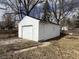 Detached one-car garage with white siding, a white garage door and single side door at 1632 W 17Th St, Anderson, IN 46016