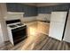 This kitchen features wooden cabinets, laminate countertops, and a gas range at 1632 W 17Th St, Anderson, IN 46016