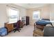 Bedroom featuring bright windows, a desk, dresser, and bed with chairs at 1840 Hibiscus Dr, Indianapolis, IN 46219
