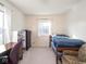 Bedroom featuring bright windows, a desk, dresser, and bed with chairs at 1840 Hibiscus Dr, Indianapolis, IN 46219