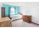 Bright bedroom features a single bed, desk, and wood dresser with ample natural light at 1840 Hibiscus Dr, Indianapolis, IN 46219