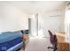 Bedroom featuring white walls, bright windows, a desk, dresser, and bed with chairs at 1840 Hibiscus Dr, Indianapolis, IN 46219