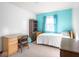 Bright bedroom has a bed, desk, wood dresser and bookshelf for optimal organization at 1840 Hibiscus Dr, Indianapolis, IN 46219