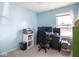 Bedroom featuring blue walls, carpet, a printer, and two computer screens on a desk at 1840 Hibiscus Dr, Indianapolis, IN 46219