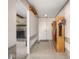 Entryway with storage and view to living area featuring stone fireplace at 1840 Hibiscus Dr, Indianapolis, IN 46219