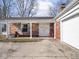 Charming front porch with seating, double doors, and brick accents, perfect for relaxing outdoors at 1840 Hibiscus Dr, Indianapolis, IN 46219
