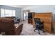Comfortable living room with a plush sofa, workspace, and view to back patio at 1840 Hibiscus Dr, Indianapolis, IN 46219