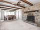 Inviting living room with stone fireplace, beamed ceiling, and an adjacent dining area at 1840 Hibiscus Dr, Indianapolis, IN 46219