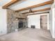View of the living room with stone fireplace and beamed ceiling at 1840 Hibiscus Dr, Indianapolis, IN 46219