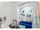 A full bathroom with shower and tub combo with built in shelving and toilet at 2123 N F St, Elwood, IN 46036