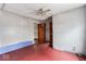 Cozy attic room with wood floors, ceiling fan and wooden louvered closet doors at 2123 N F St, Elwood, IN 46036
