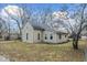 Quaint exterior of home with mature trees and a simple yard at 2123 N F St, Elwood, IN 46036