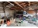 Interior shot of a cluttered, detached garage with overhead lighting at 2123 N F St, Elwood, IN 46036