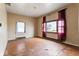 A vacant living room, featuring hardwood floors, textured walls, and natural light at 2123 N F St, Elwood, IN 46036