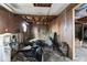 Damaged living room interior featuring debris, water damage, and wall paneling at 2123 N F St, Elwood, IN 46036