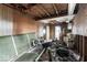 Dilapidated room with extensive damage to walls, ceiling, and debris scattered throughout at 2123 N F St, Elwood, IN 46036