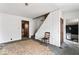 Living room with staircase, large window, and access to other rooms at 2123 N F St, Elwood, IN 46036
