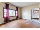 Unfurnished living room featuring hardwood floors, textured walls, and natural light at 2123 N F St, Elwood, IN 46036