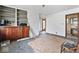 A partially furnished room with hardwood floors, a built-in cabinet, and natural light at 2123 N F St, Elwood, IN 46036