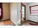 Unfurnished room with hardwood floors, textured walls, and a four-panel door at 2123 N F St, Elwood, IN 46036