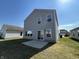 Rear exterior view of a two story home with a lush lawn and concrete patio at 2402 Middle View Dr, Columbus, IN 47201