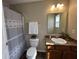 Compact bathroom with shower and tub, single vanity, and well lit mirror at 2402 Middle View Dr, Columbus, IN 47201