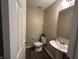Half bath featuring a pedestal sink, wood floors, and neutral color scheme at 2402 Middle View Dr, Columbus, IN 47201