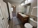 Well lit bathroom features double sink vanity and an open doorway to a carpeted bedroom at 2402 Middle View Dr, Columbus, IN 47201