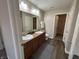 Bathroom features dual sinks, granite countertops and walk-in closet at 2402 Middle View Dr, Columbus, IN 47201