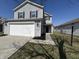 Charming two-story home with attached garage, black shutters and manicured landscaping at 2402 Middle View Dr, Columbus, IN 47201