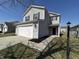 Charming two-story home with attached garage, black shutters and manicured landscaping at 2402 Middle View Dr, Columbus, IN 47201