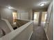 Bright upper hallway featuring three doorways to bedrooms and a conveniently located full bathroom at 2402 Middle View Dr, Columbus, IN 47201