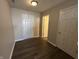 Hallway view showcasing wood floors and multiple doors leading to various rooms at 2402 Middle View Dr, Columbus, IN 47201