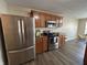 Gourmet kitchen with stainless steel appliances, wood cabinets, and a breakfast bar at 2402 Middle View Dr, Columbus, IN 47201