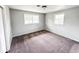Cozy bedroom with two windows, plush carpeting and freshly painted gray walls at 3008 Nichol Ave, Anderson, IN 46011